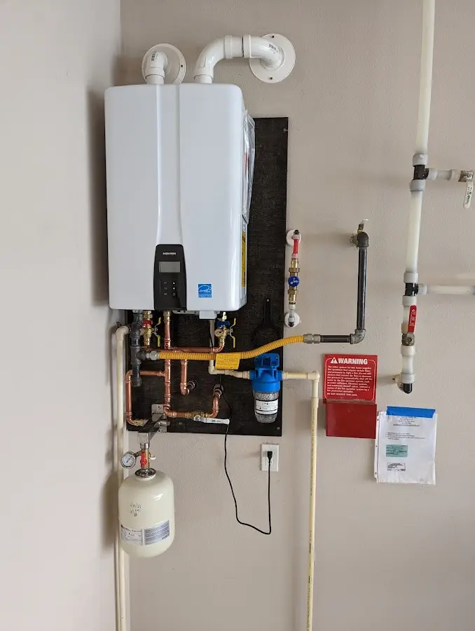 Professional plumber installing copper piping in a Otsego home